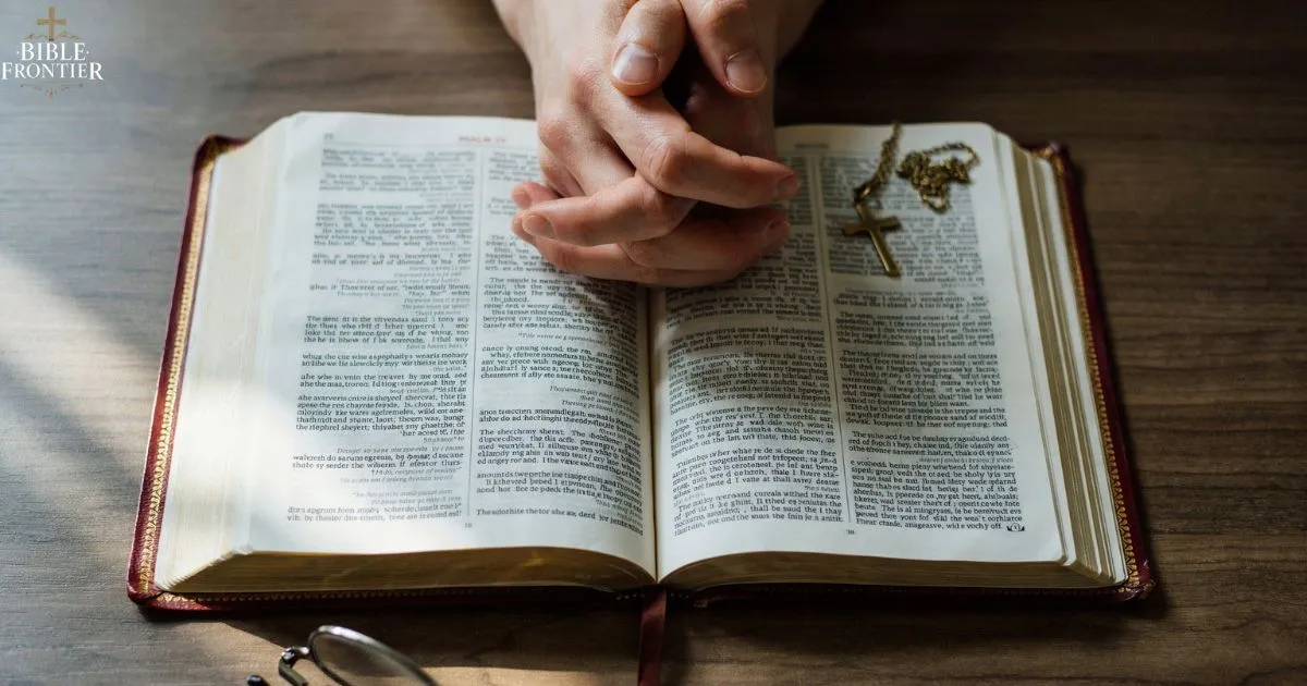 Folded hands in prayer resting on an open Bible, a simple prayer to trust God completely